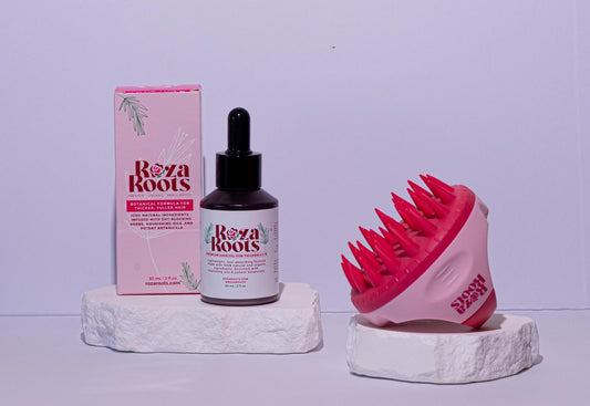 Bottle of Roza Roots herbal hair oil on wooden table